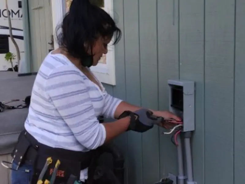 Licensed electrician wiring an exterior subpanel in Tabernacle